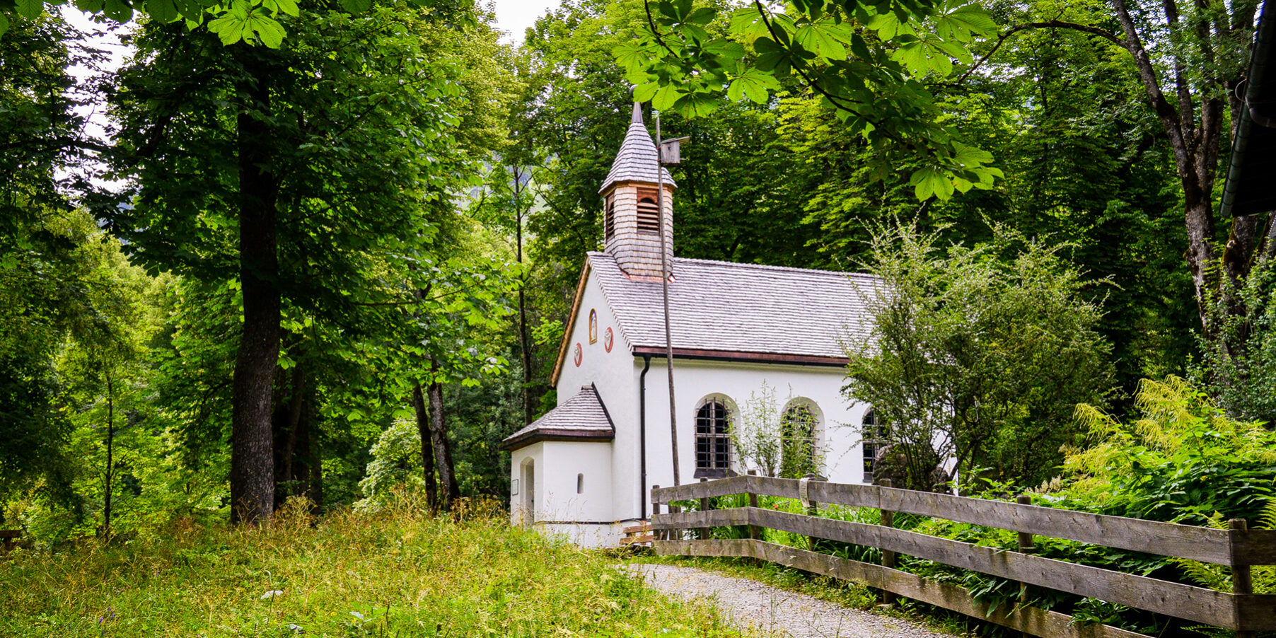 Closeup shot of a little white church in the woods A small country church