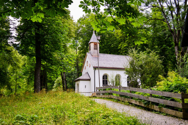 Closeup shot of a little white church in the woods A small country church