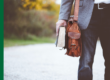 Pastor holding both a Bible and a briefcase