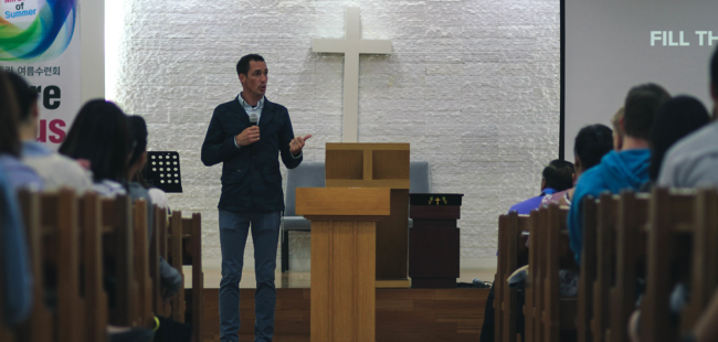 congregations-thrive-without-full-time-clergy Pastor preaching from the front of a church