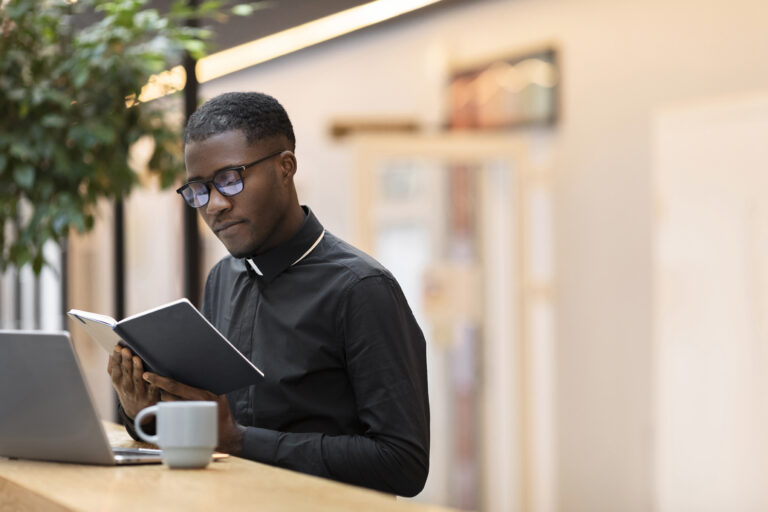 Young priest studying